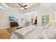Bright main bedroom with tray ceilings, plantation shutters, and a cozy sitting area at 266 Riverwood Rd, Mooresville, NC 28117