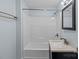 Bright bathroom featuring a bathtub and shower combination with a modern vanity and mirror at 310 S Spencer Ave, Spencer, NC 28159