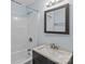 Well-lit bathroom with a bathtub and shower, featuring a modern vanity with sink and mirror at 310 S Spencer Ave, Spencer, NC 28159