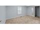 Bedroom with neutral carpet, window and closet, offering a clean and versatile space at 310 S Spencer Ave, Spencer, NC 28159