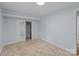 A bedroom with neutral carpet, a closet with sliding doors, and fresh paint at 310 S Spencer Ave, Spencer, NC 28159
