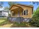 Charming yellow house with a gray foundation, dark shutters, and a cozy front porch at 310 S Spencer Ave, Spencer, NC 28159