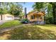 Charming yellow home featuring a detached garage, blooming hydrangeas, and inviting front porch at 310 S Spencer Ave, Spencer, NC 28159