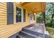 Inviting front porch showcasing the house number, gray stairs, and gray shutters at 310 S Spencer Ave, Spencer, NC 28159