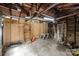 Spacious unfinished garage with exposed rafters, concrete floors, and plywood walls at 310 S Spencer Ave, Spencer, NC 28159