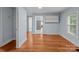 Hallway with hardwood floors leads to kitchen with tile at 310 S Spencer Ave, Spencer, NC 28159