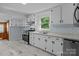 Bright kitchen with white cabinets, stainless steel appliances, and marble tile floors at 310 S Spencer Ave, Spencer, NC 28159