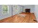 Living room featuring hardwood floors, natural light, and a fireplace, offering warmth and charm at 310 S Spencer Ave, Spencer, NC 28159