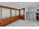Mud room with a door to the outside, wood paneling, and a utility sink and washer/dryer hookup at 310 S Spencer Ave, Spencer, NC 28159