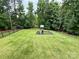 View of the spacious, grassy, fenced backyard with a playset at 3110 Richards Way Dr, Rock Hill, SC 29732