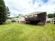 Large, grassy backyard with a wooden deck and a screened porch at 3110 Richards Way Dr, Rock Hill, SC 29732