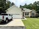 Charming home boasts a well-manicured lawn, two-car garage, and stone accents around windows and entrance at 3110 Richards Way Dr, Rock Hill, SC 29732