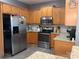 Well-lit kitchen featuring stainless steel appliances, granite countertops, and wooden cabinets at 3110 Richards Way Dr, Rock Hill, SC 29732