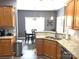 Features of a kitchen that opens to the dining area with granite countertops and wooden cabinets at 3110 Richards Way Dr, Rock Hill, SC 29732
