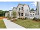 View of newly built townhomes featuring well-kept lawns, sidewalks and attractive curb appeal at 3932 Hager Dr, Charlotte, NC 28208