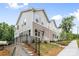 New townhome exterior with a retaining wall, showcasing the architectural design and community aesthetics at 3932 Hager Dr, Charlotte, NC 28208