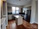 Modern kitchen with an island, sleek appliances, and hardwood floors at 408 N Mcdowell St, Charlotte, NC 28204