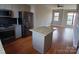Open-concept kitchen with stainless steel appliances and a center island at 408 N Mcdowell St, Charlotte, NC 28204