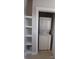 Convenient laundry closet with shelves and a stacked washer and dryer at 408 N Mcdowell St, Charlotte, NC 28204