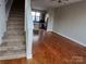 Open living space with hardwood floors next to the modern kitchen and staircase at 408 N Mcdowell St, Charlotte, NC 28204