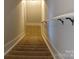Carpeted staircase with a secure handrail guides you safely between levels at 408 N Mcdowell St, Charlotte, NC 28204