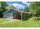 Spacious backyard with patio area, lush green lawn, and mature trees, perfect for outdoor living at 409 S Grove St, Lincolnton, NC 28092