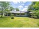 Expansive backyard featuring a well-maintained lawn, mature trees, and charming home exterior at 409 S Grove St, Lincolnton, NC 28092