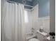 Cozy bathroom with white subway tile, blue walls and shower with curtain at 409 S Grove St, Lincolnton, NC 28092