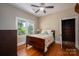 Comfortable bedroom with hardwood floors, a ceiling fan, and a bright window at 409 S Grove St, Lincolnton, NC 28092