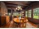 Spacious dining room has wood floors, wood trim, a patterned rug, a round wood table, and a view into the living room at 409 S Grove St, Lincolnton, NC 28092