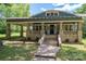 Charming blue home featuring a stone porch with inviting stairway and classic architectural details at 409 S Grove St, Lincolnton, NC 28092