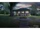 Exterior shot of home at night, with beautiful front yard flowers and landscaped pathway at 409 S Grove St, Lincolnton, NC 28092
