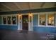 Exterior of house featuring a cozy porch area and beautiful dark wooden front door at 409 S Grove St, Lincolnton, NC 28092