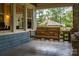 Cozy front porch featuring a wooden porch swing and views of the neighborhood at 409 S Grove St, Lincolnton, NC 28092