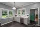 Charming kitchen features bright white cabinets, stainless steel dishwasher, subway tile, and a view to the backyard at 409 S Grove St, Lincolnton, NC 28092