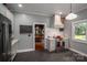 Bright kitchen shows a stainless steel stove with hood, gray cabinets and counters, and a view into the dining room at 409 S Grove St, Lincolnton, NC 28092