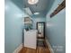 Bright laundry room with modern washer and dryer, storage shelves, and stylish decor at 409 S Grove St, Lincolnton, NC 28092