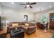 Open-concept living room connected to dining area with hardwood floors and neutral tones at 409 S Grove St, Lincolnton, NC 28092