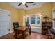 Bright office with wood desk, hardwood floors, built-in window seat, and large window allowing for natural light at 409 S Grove St, Lincolnton, NC 28092