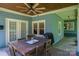 Cozy outdoor patio with dining table, ceiling fan, and views of the surrounding yard at 409 S Grove St, Lincolnton, NC 28092