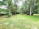 Spacious backyard with mature trees and well-maintained lawn, perfect for outdoor activities at 423 N Cedar St, Lincolnton, NC 28092