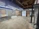 Spacious basement with windows, brick walls, and concrete floors, awaiting finishing touches at 423 N Cedar St, Lincolnton, NC 28092