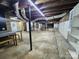 Spacious unfinished basement featuring concrete floors, exposed ductwork, and supporting columns at 423 N Cedar St, Lincolnton, NC 28092