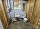Basement bathroom with basic toilet, sink, and wood framing ready for final finishes at 423 N Cedar St, Lincolnton, NC 28092