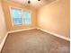 Comfortable bedroom showcasing neutral carpeting, ample natural light, and a calming atmosphere at 423 N Cedar St, Lincolnton, NC 28092