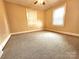 Cozy bedroom featuring neutral carpeting, bright natural light, and a ceiling fan at 423 N Cedar St, Lincolnton, NC 28092