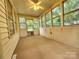 Bright sunroom with multiple windows and painted trim, perfect for relaxation and enjoyment at 423 N Cedar St, Lincolnton, NC 28092