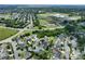 An aerial view of a neighborhood featuring mature landscaping and a school with sports facilities at 4915 Juniper Grove Sw Ct, Concord, NC 28027