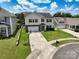 Aerial view of a two-story home with a driveway, well-manicured lawn, and a landscaped yard at 4915 Juniper Grove Sw Ct, Concord, NC 28027