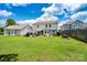 Spacious backyard featuring lush green grass, a pergola, and beautiful landscaping for outdoor enjoyment at 4915 Juniper Grove Sw Ct, Concord, NC 28027